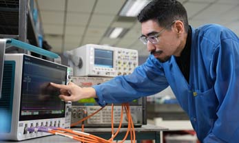 Man testing a newly calibrated oscilloscope