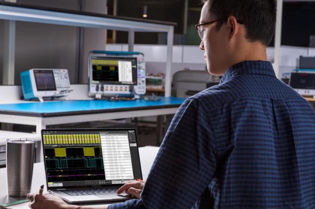 Engineer viewing an oscilloscope waveform on a laptop computer