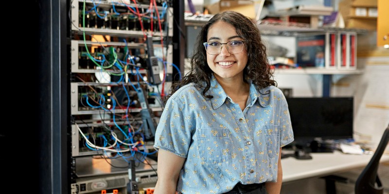 A woman in a blue shirt, in a service center.