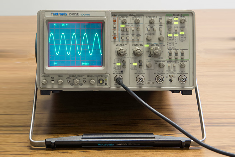 Picture of analog oscilloscope displaying a sinewave
