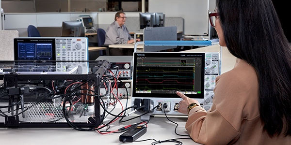 Image of a female engineer performing on-scope analysis of a motor drive using a Tektronix 4 Series B Mixed Signal Oscilloscope.