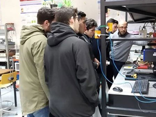 University students exploring a lab power supply with an instructor