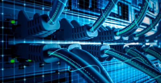 Close-up of network cables connected to a switch in a data center, with glowing blue lines indicating data transfer.