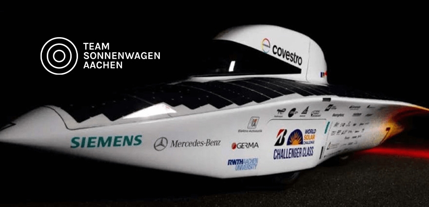 Front view of the Covestro Adelie solar-powered race car by Team Sonnenwagen Aachen, showcasing its aerodynamic design and sponsor logos, including Covestro and Mercedes-Benz.