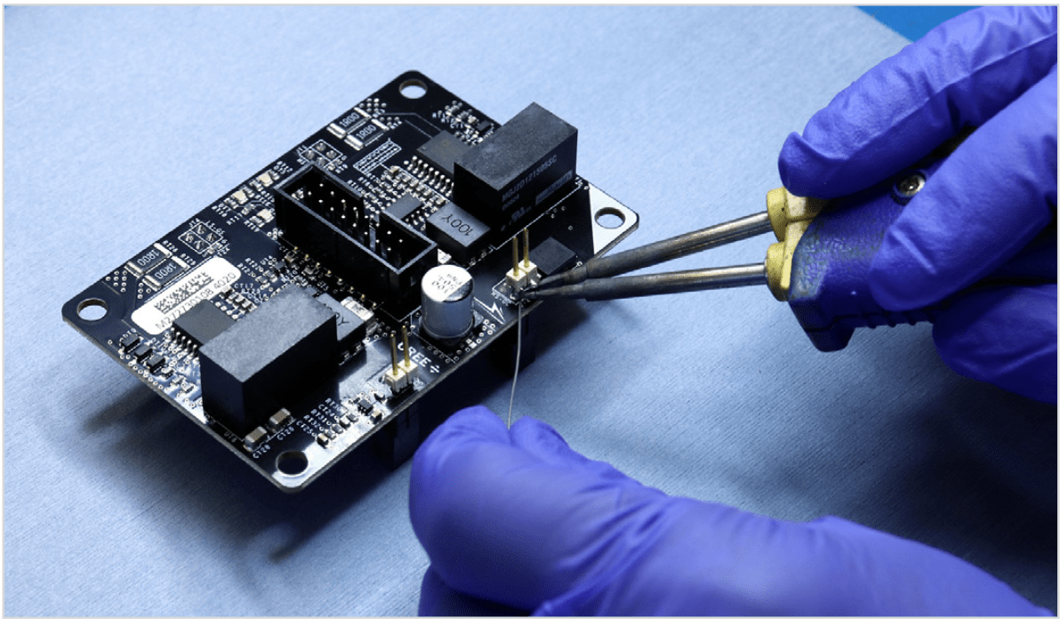 Soldering a square pin header across VGS nodes to measure high-side gate drive signal. Photo © Wolfspeed. Reprinted with permission