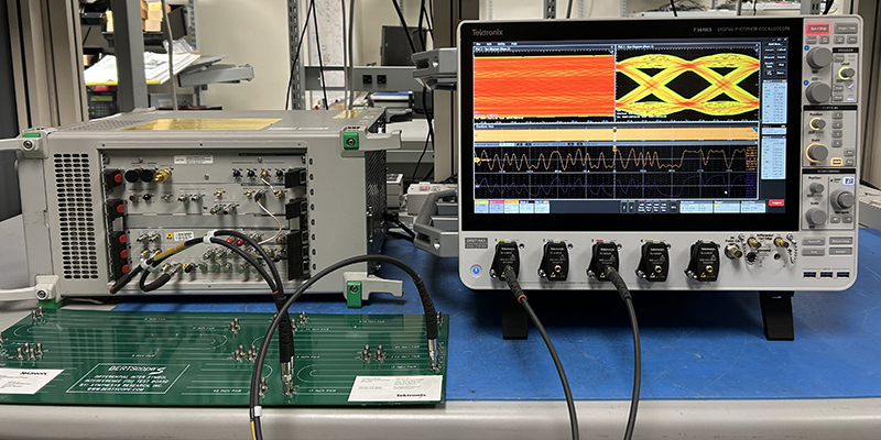 Test set up on a bench in an engineering lab showing a BERT scope connected to a PRBS board and the 7 Series DPO oscilloscope to measure the test results.